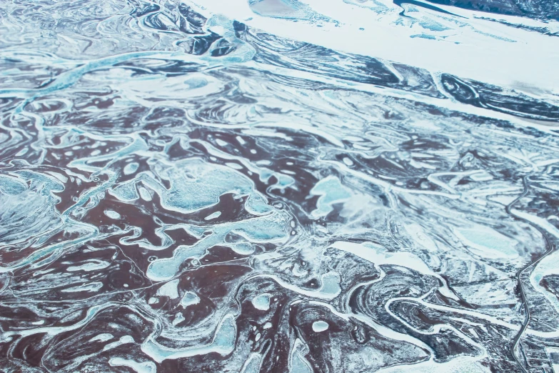 aerial view of ice covered mountains from an airplane