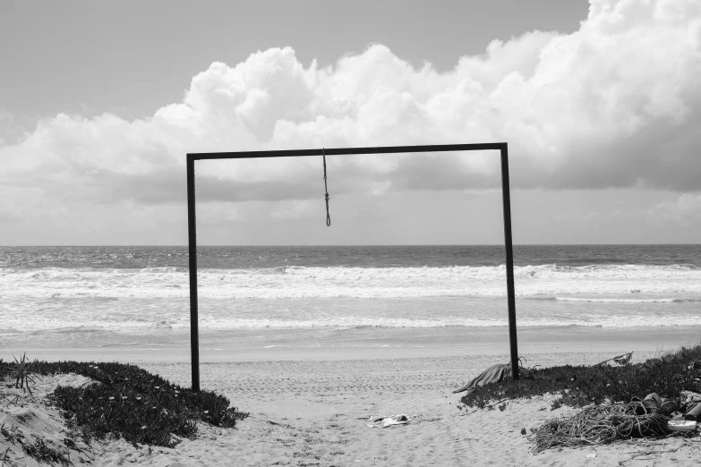 an empty soccer goal at the beach