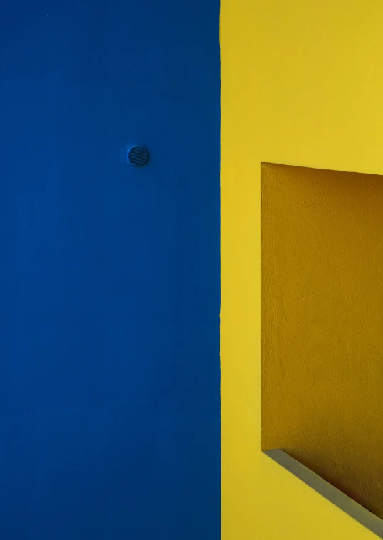 a blue and yellow room with a yellow wall