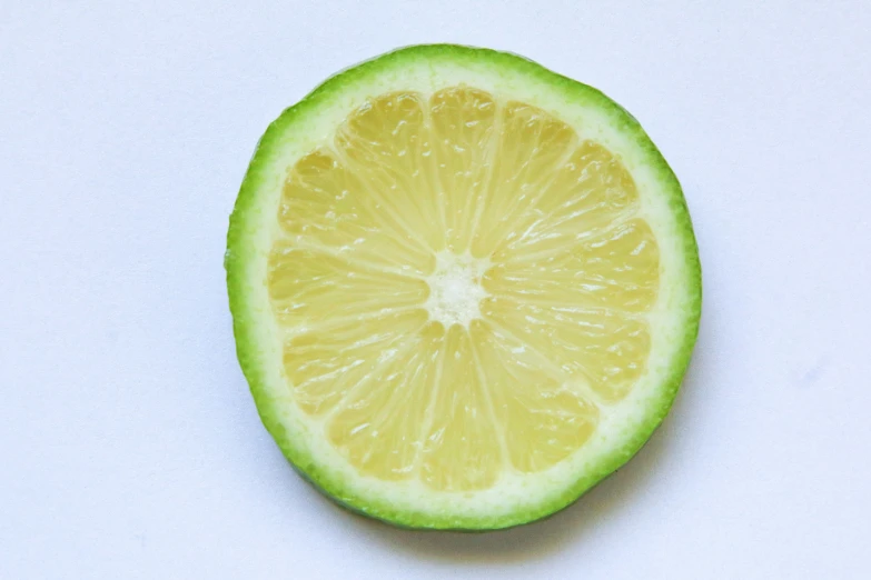 a slice of lime on a white surface