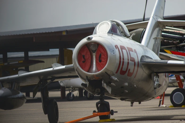 an older plane is parked on the runway