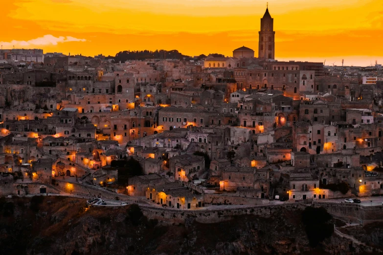 view of some buildings and a clock tower at sunset