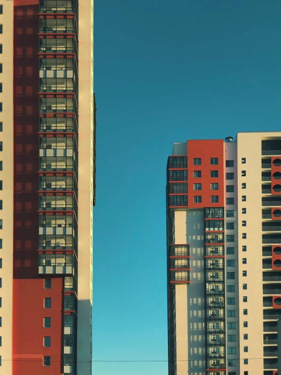 multiple multi - story building on the left and tall building on right