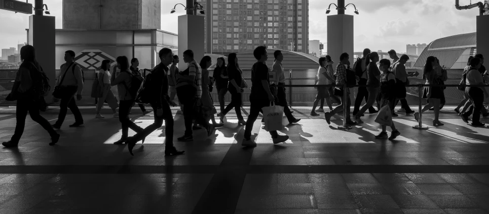 people walking on sidewalk in city on very cloudy day