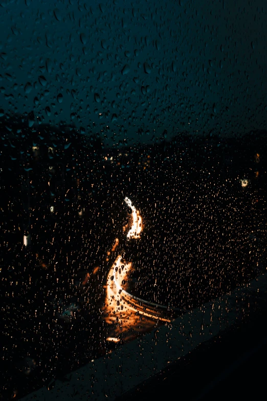 the view of the rain is shown through the windshield
