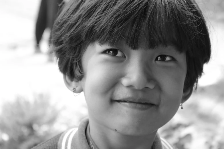 a close up of a child wearing a necklace