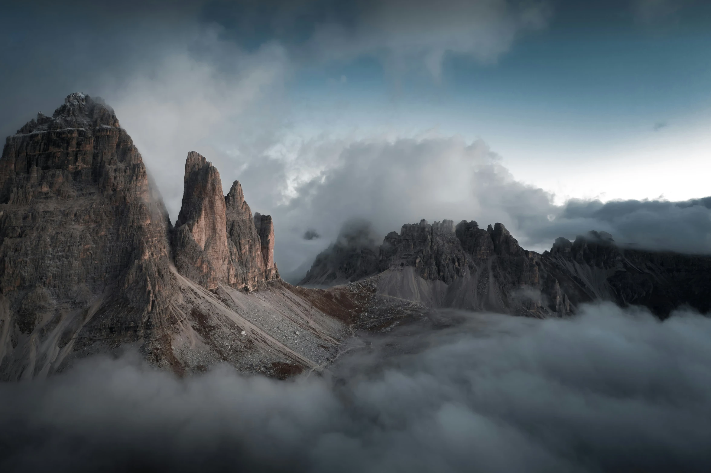 a mountain range on top of a cloud covered mountain