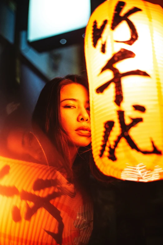 a woman with a chinese lantern in her hand