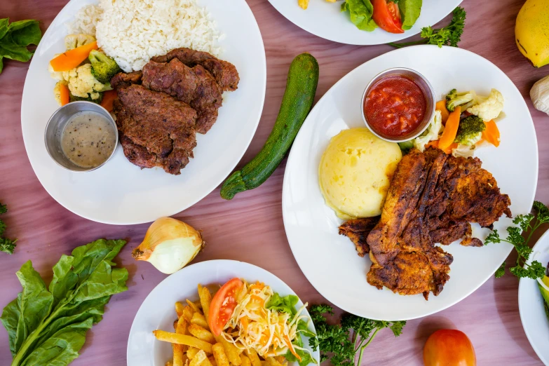 three plates with food on them and some vegetables