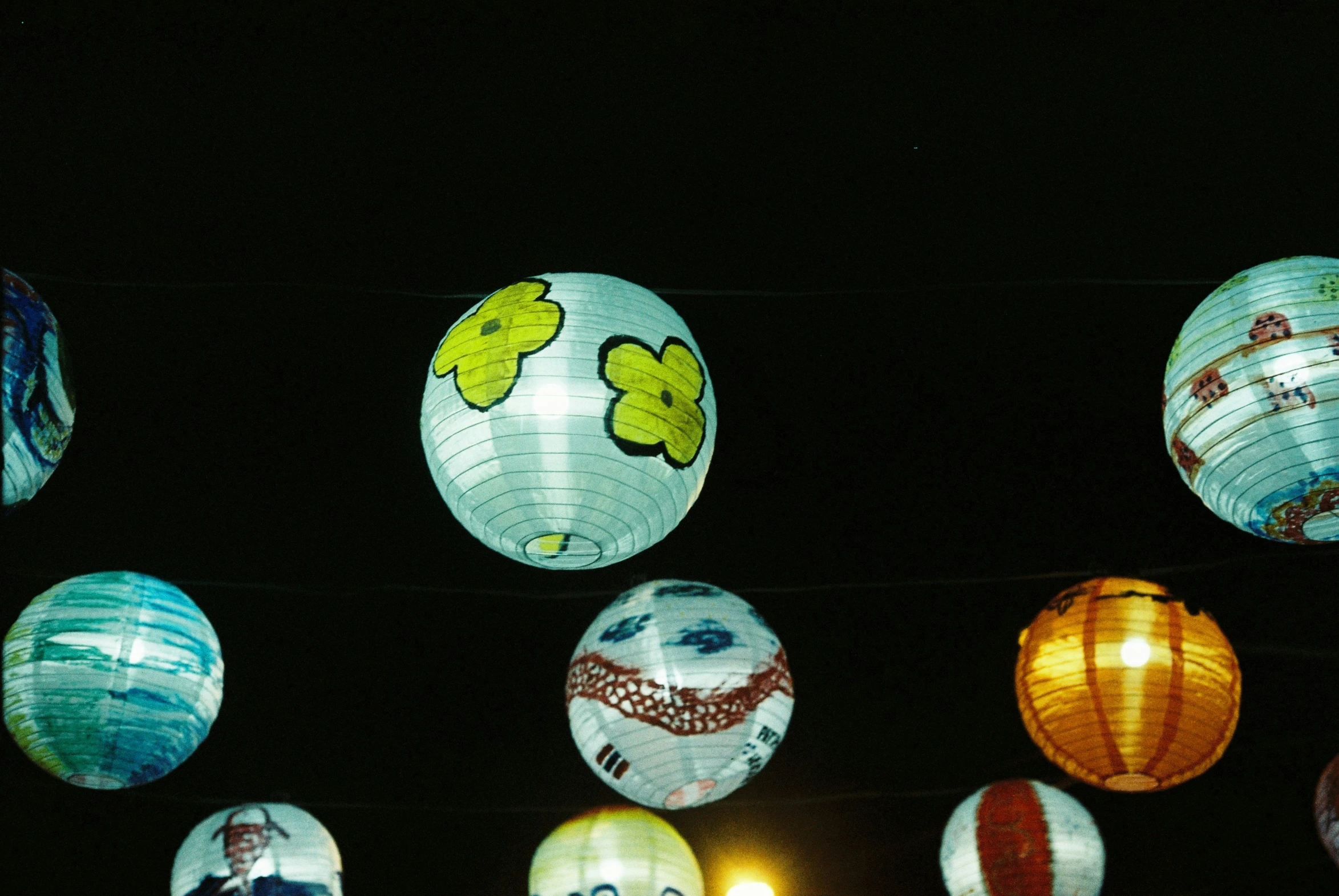 a group of small lights hanging from strings