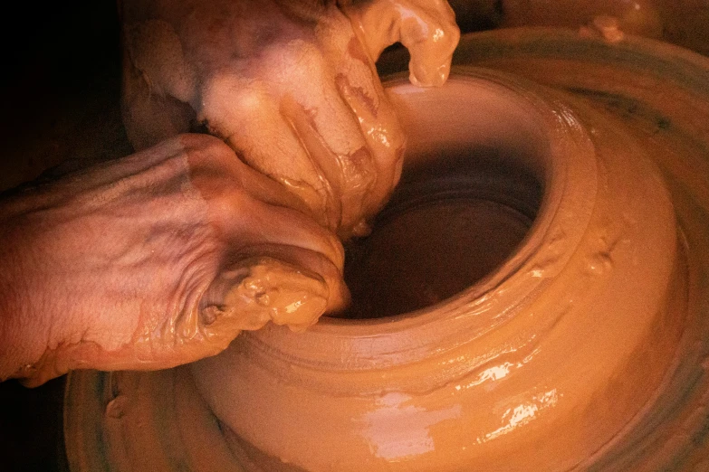 a woman makes clay using one piece of pottery