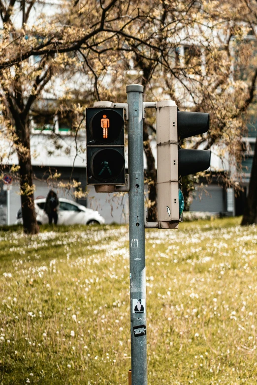 there is a no walk sign next to a street light