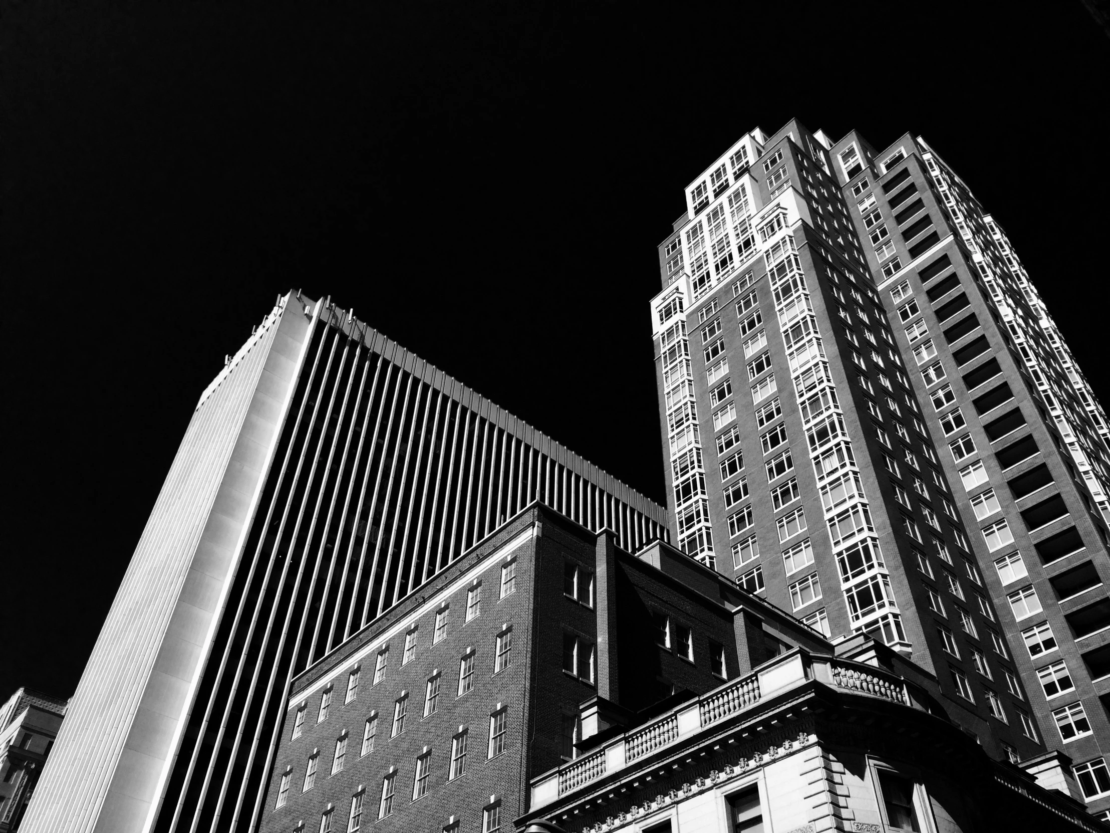 very tall buildings in a city in black and white