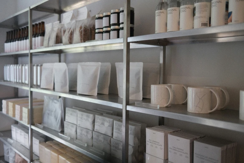 various white containers, stacks, and boxes are on the shelves