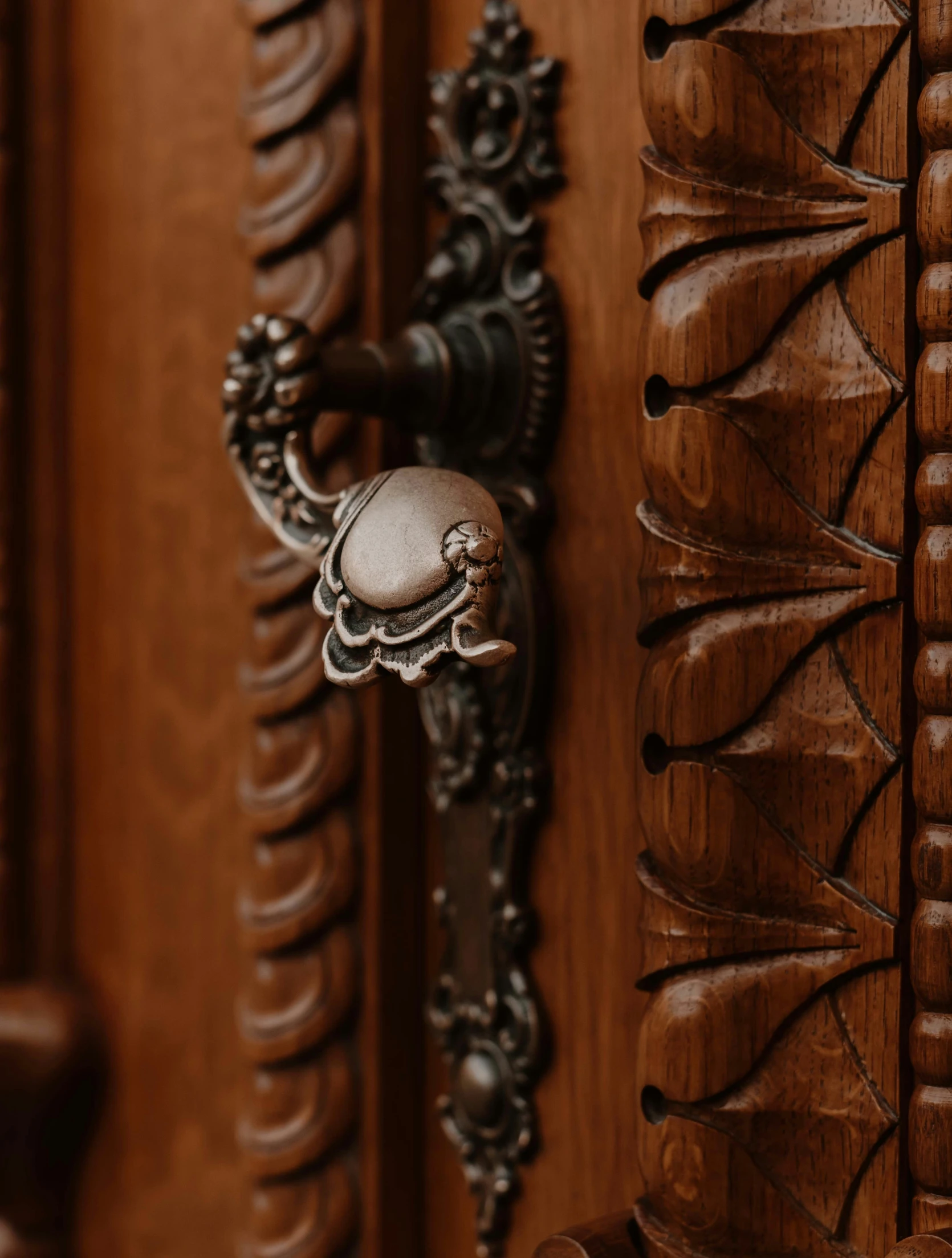 an ornate wooden door with an intricately carved handle