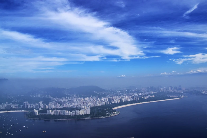 blue and white clouds over a body of water