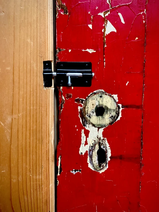 a door with paint on it and a latch