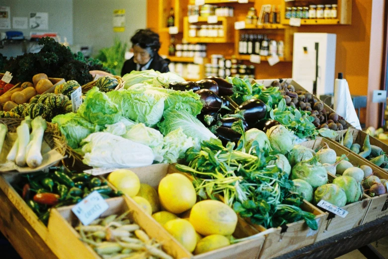 a table with some bins of fruits and vegetables