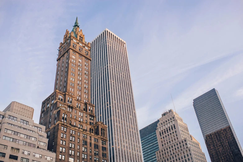 tall buildings in a city with sky reflected