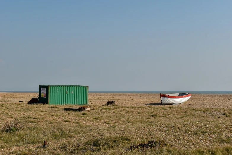 two boats and a container are standing on the beach