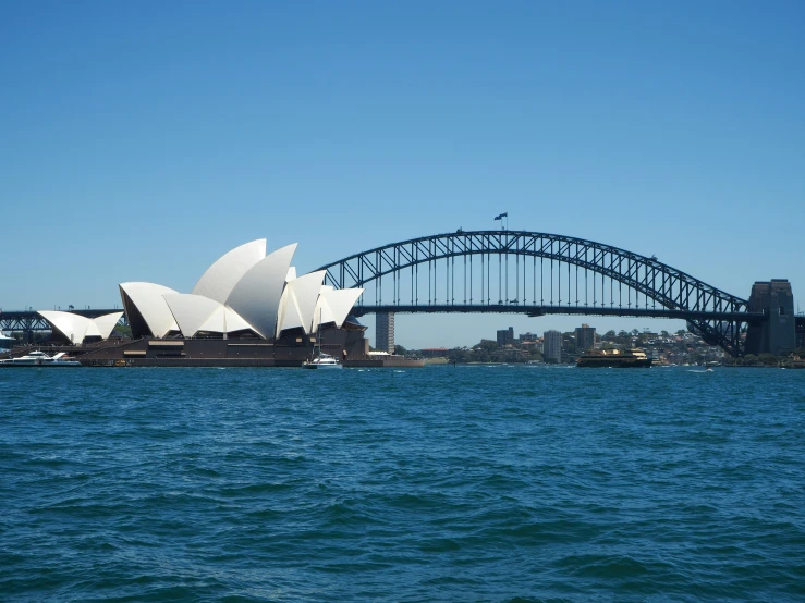 a sydney harbour with opera house and the sydney bridge