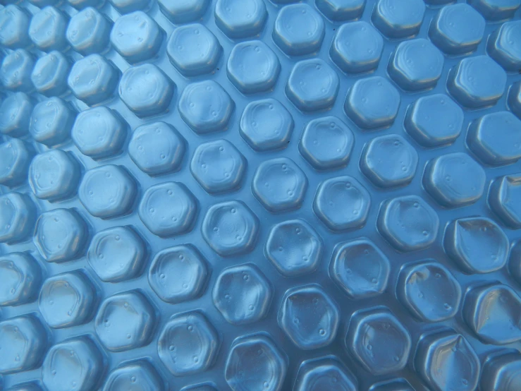 a large blue, round tile sitting under water