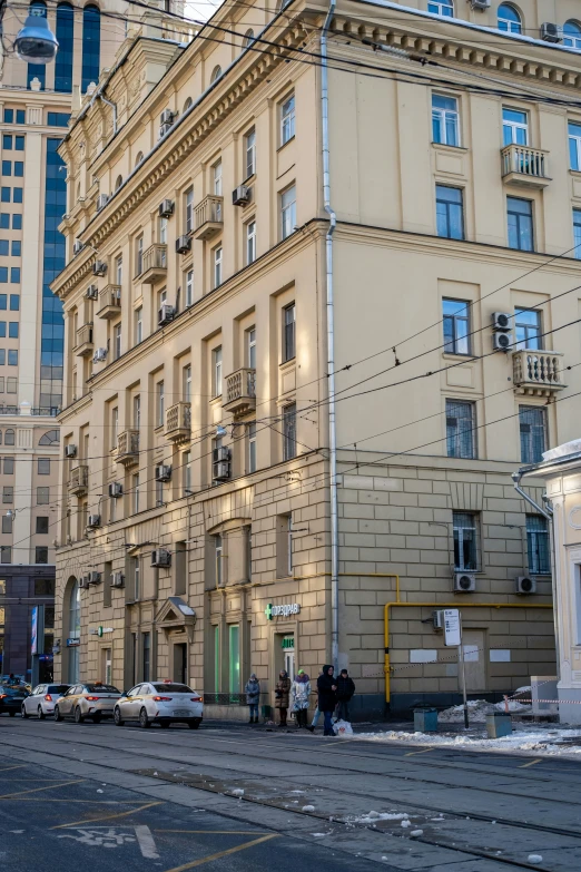 a line of cars parked along side of buildings