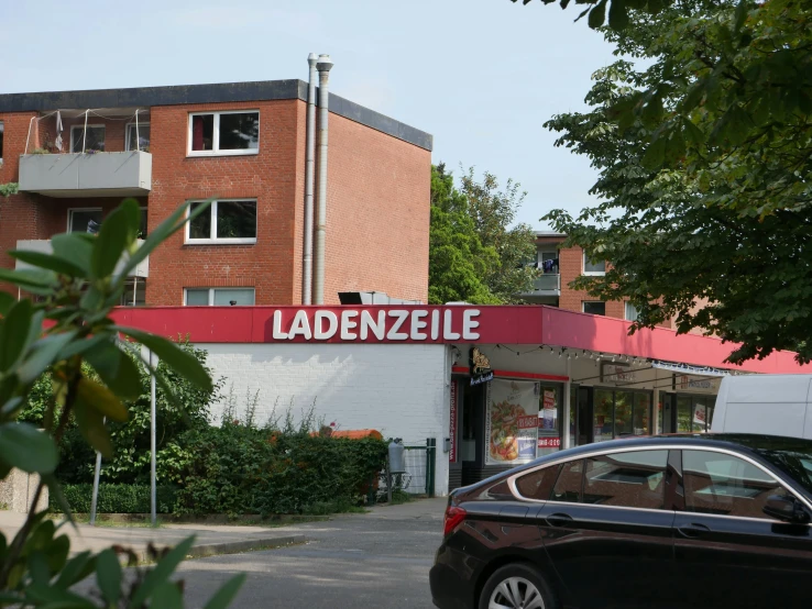 an apartment building with a sign that reads ladies - eze