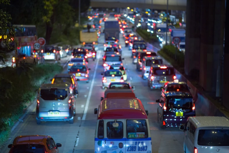 there are a lot of cars and vans driving on the street