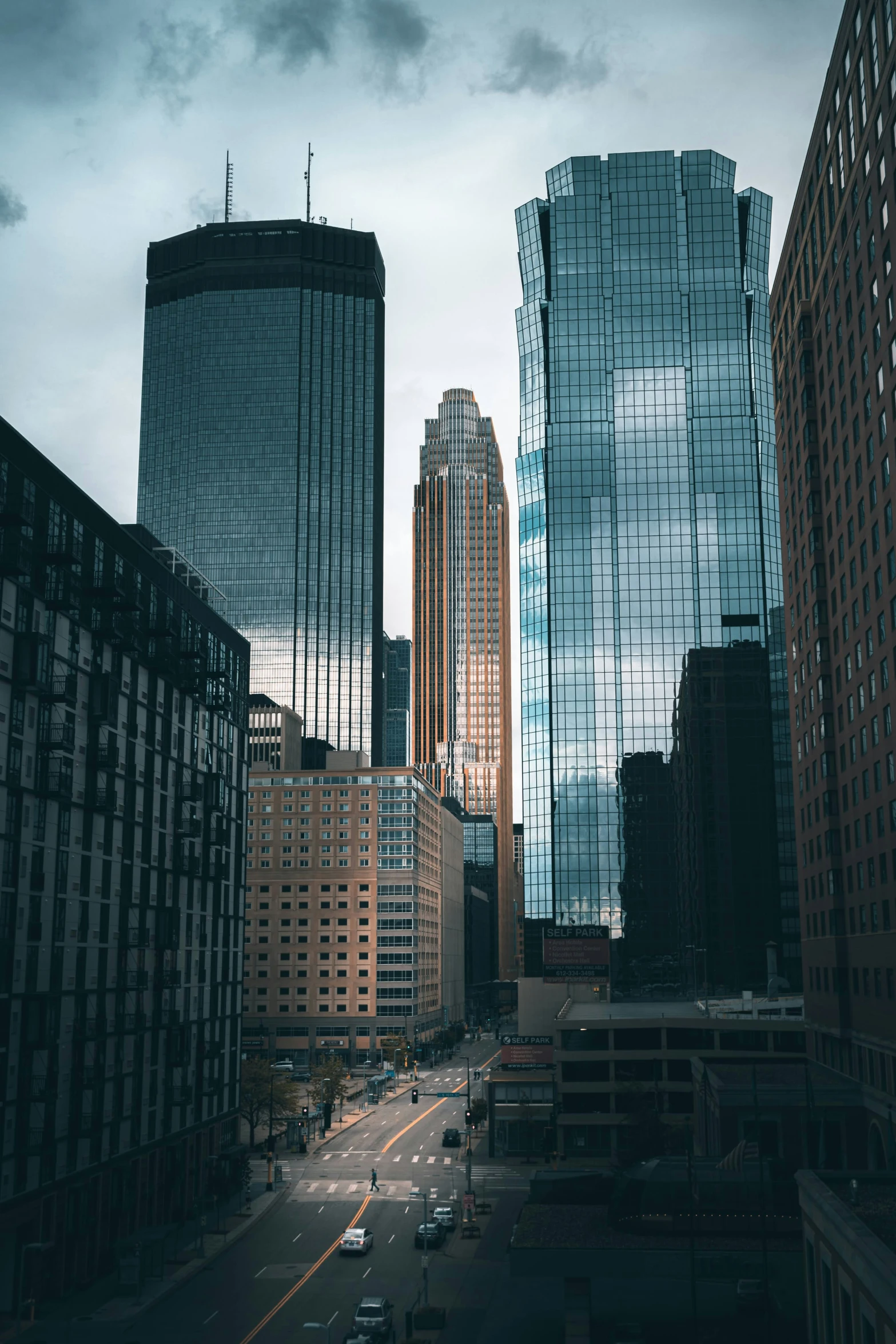 city skyline from an aerial view with street in the foreground and skyscrs in the background