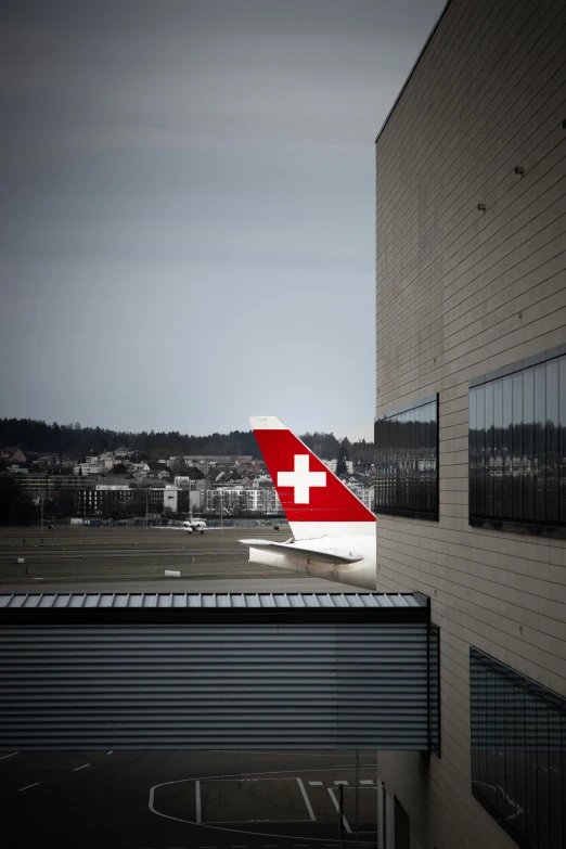 a red and white airplane is parked on the tarmac