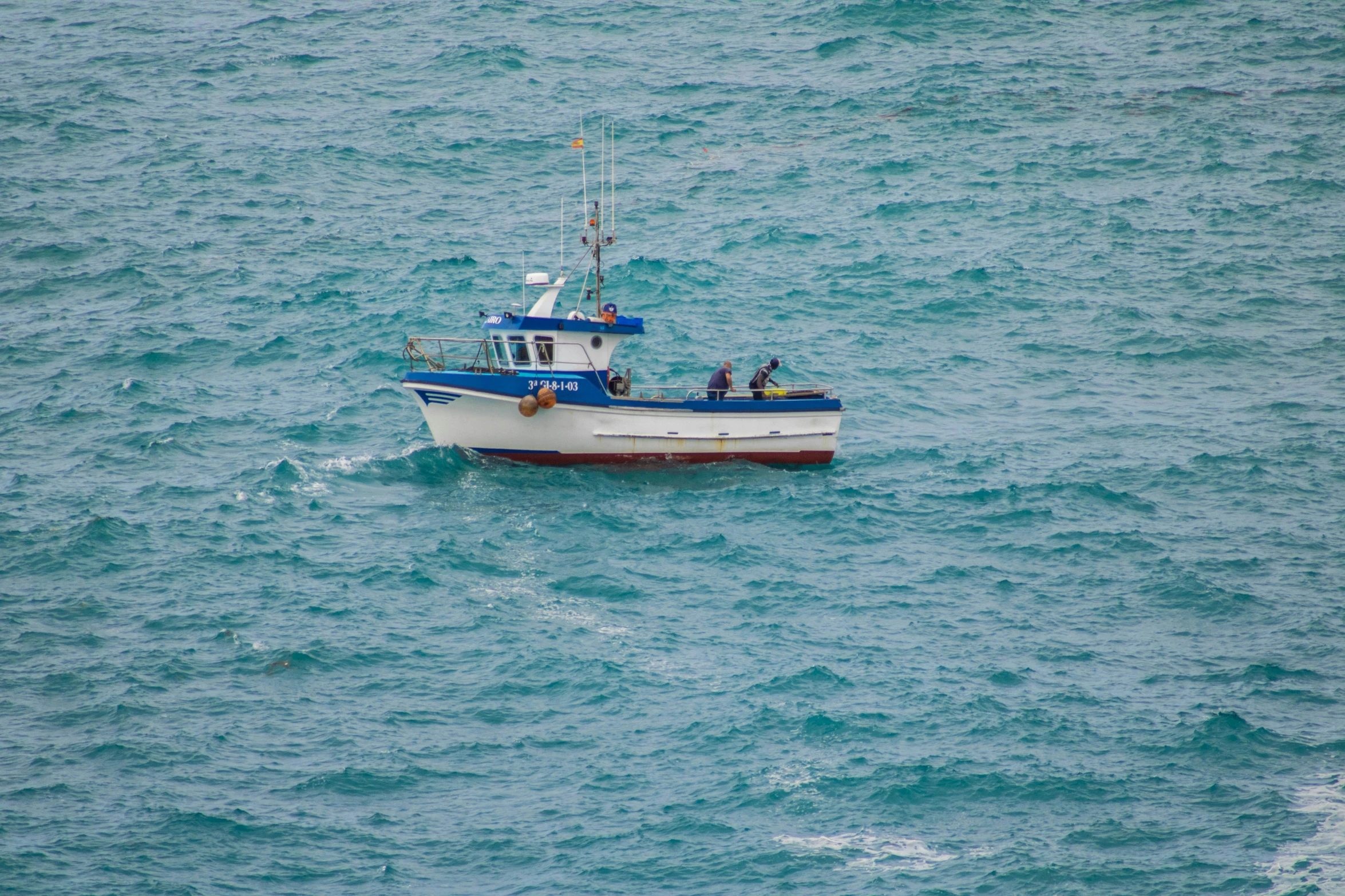 a boat floats in open water off the coast