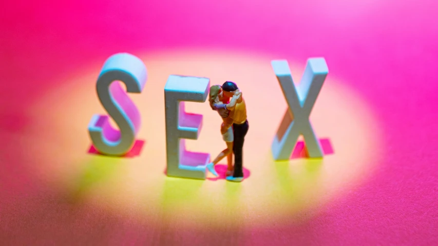 a couple kissing next to the word sex