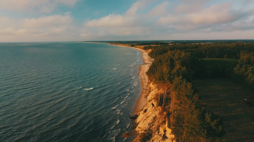 a shoreline in front of an ocean with a dirt shore