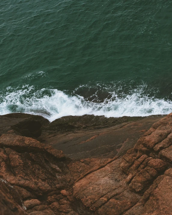 a bird's eye view of a shoreline with water