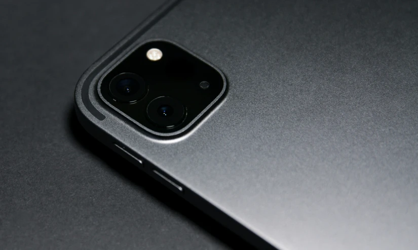 a close up of a black phone showing its camera lens