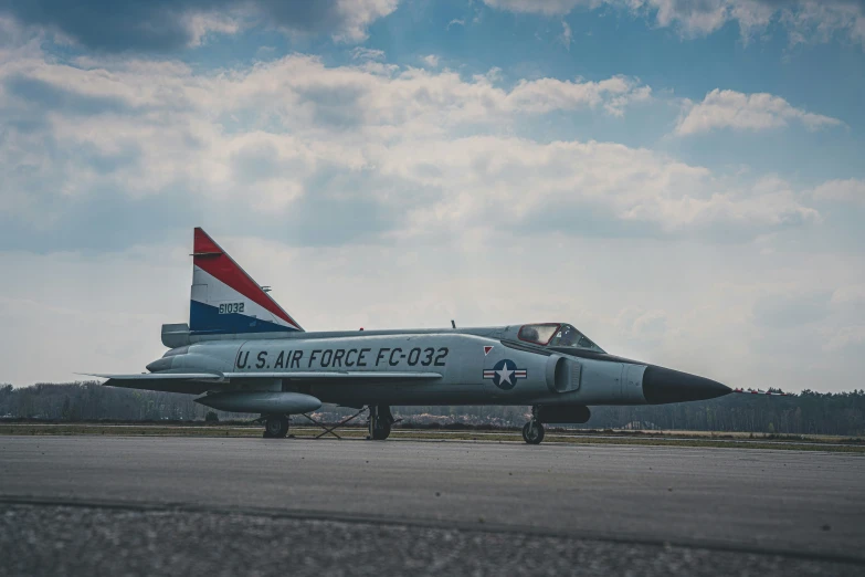 a gray military aircraft sitting on a runway