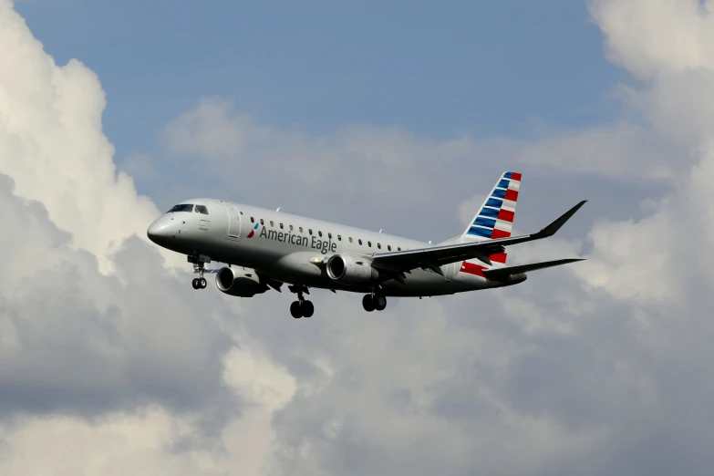 an american airlines plane flies through the sky