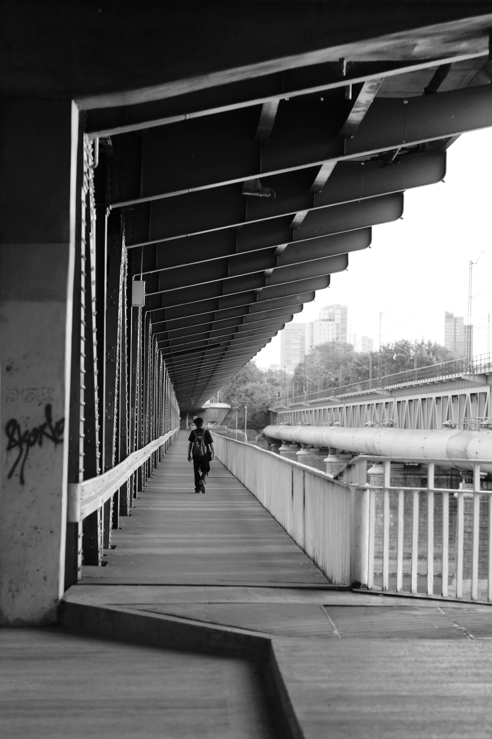 a man is walking over a wooden bridge