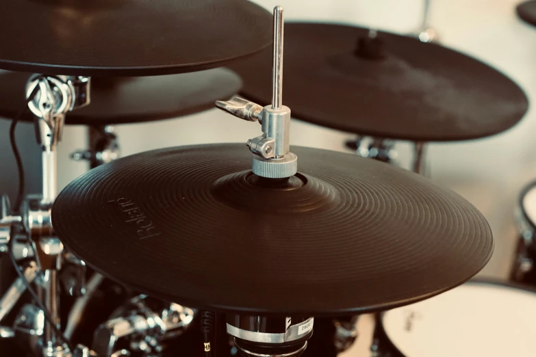 a black drum head sits on a shiny black drum