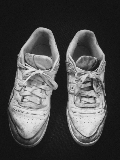 black and white pograph of two tennis shoes