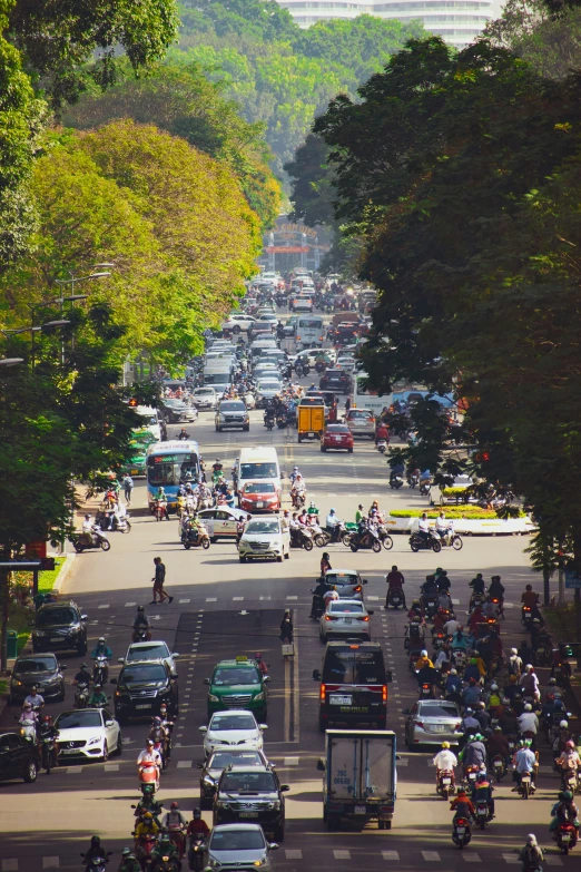 a city street with large crowds of people riding scooters