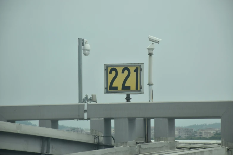 a street sign with numbers at the top is above a pedestrian walk