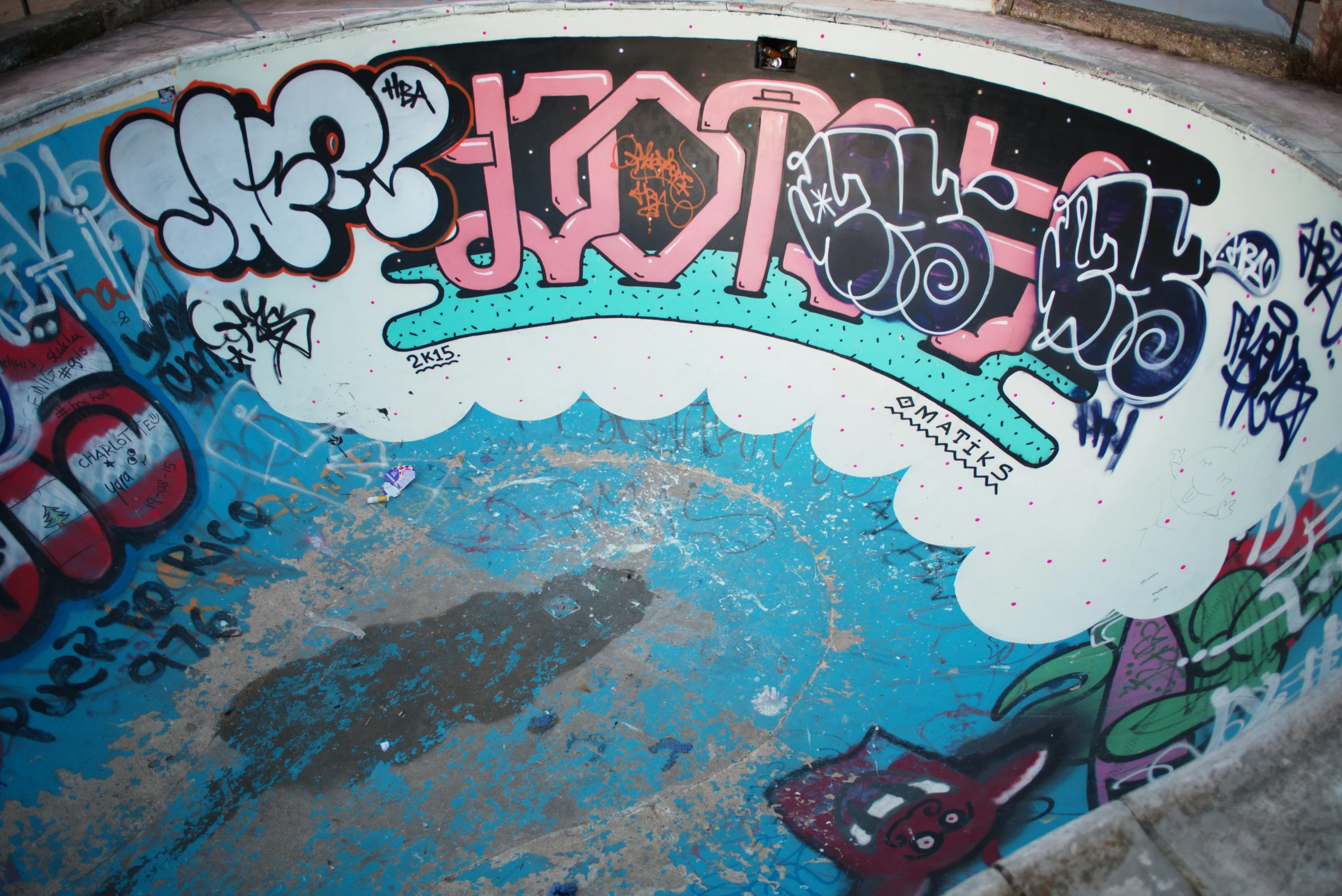 the back wall of a skateboard park with graffiti