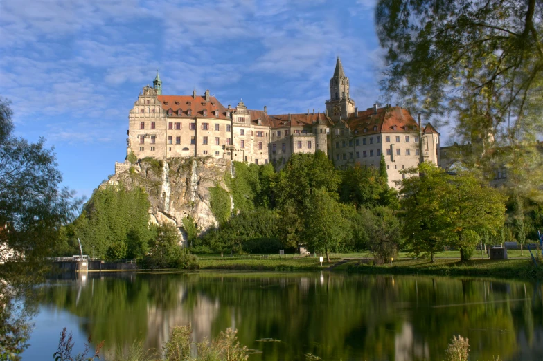 the water is crystal blue outside and in front of this castle