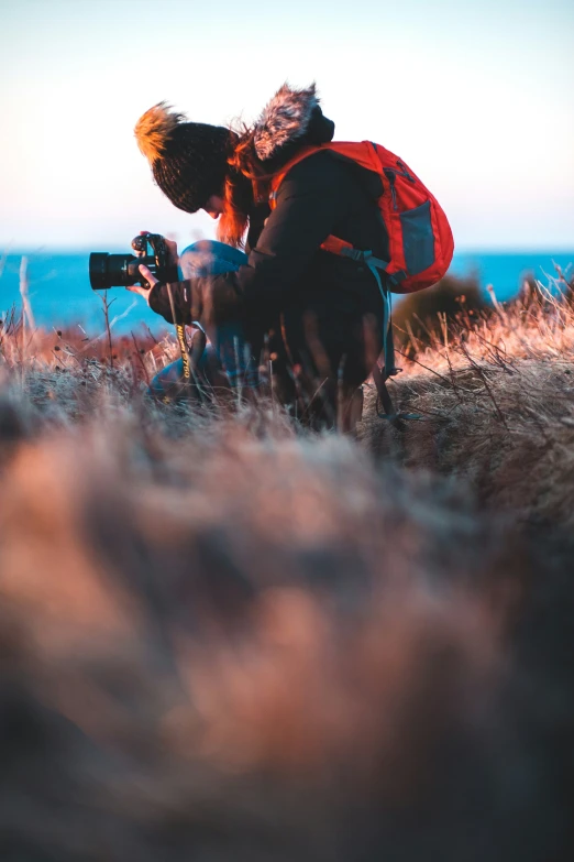 there are two people kneeling next to each other in the grass