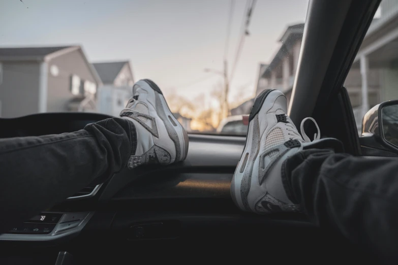 a person sitting in their car while holding the dashboard