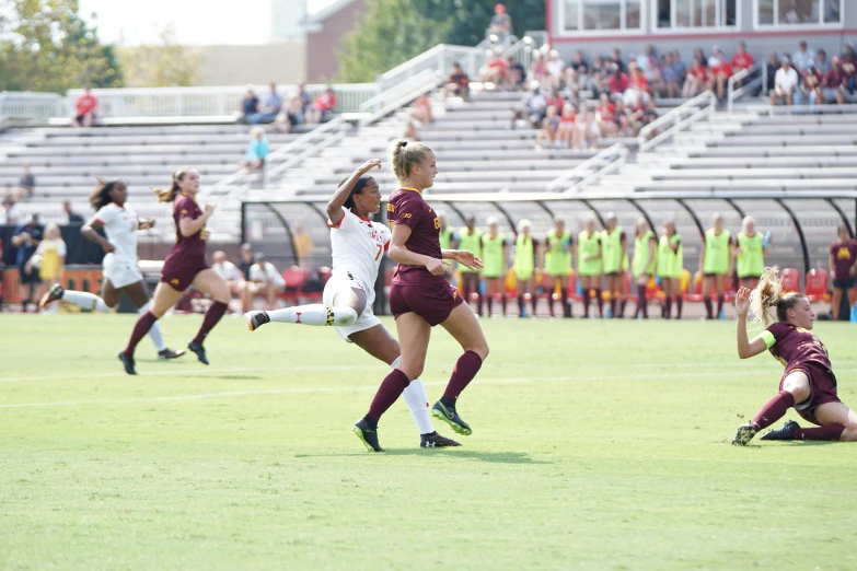 girls soccer players during a game in front of a crowd