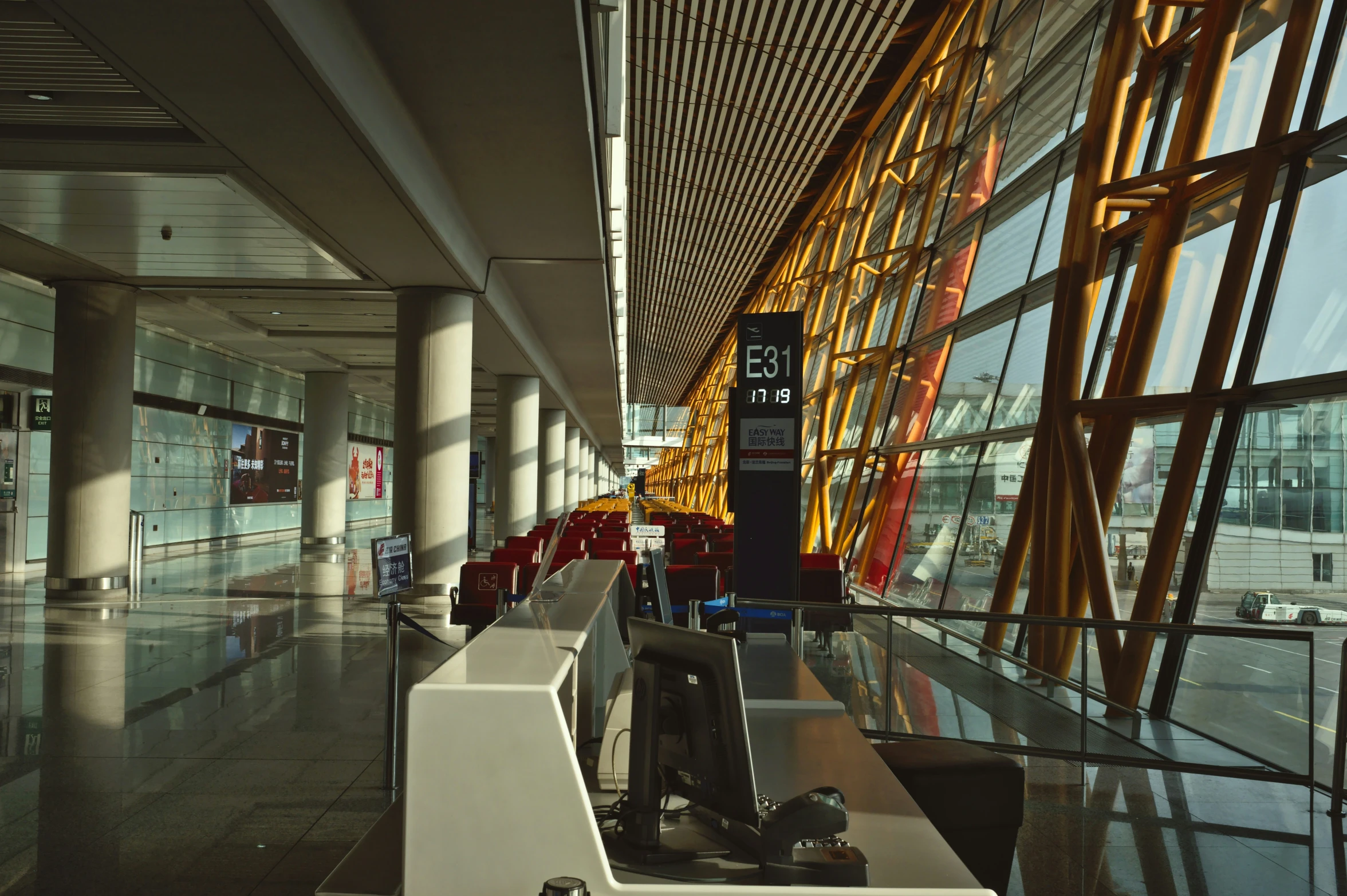 a luggage carousel at the end of a lobby