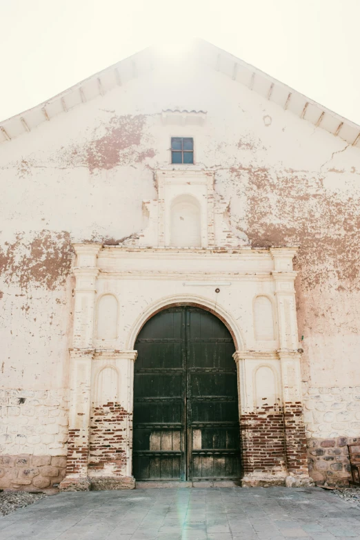 a white stone building with a black gate